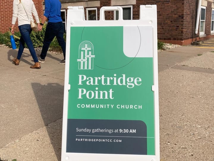 Horizontal sign that says Partridge Point Community Church, Sunday gatherings at 9:30 am.